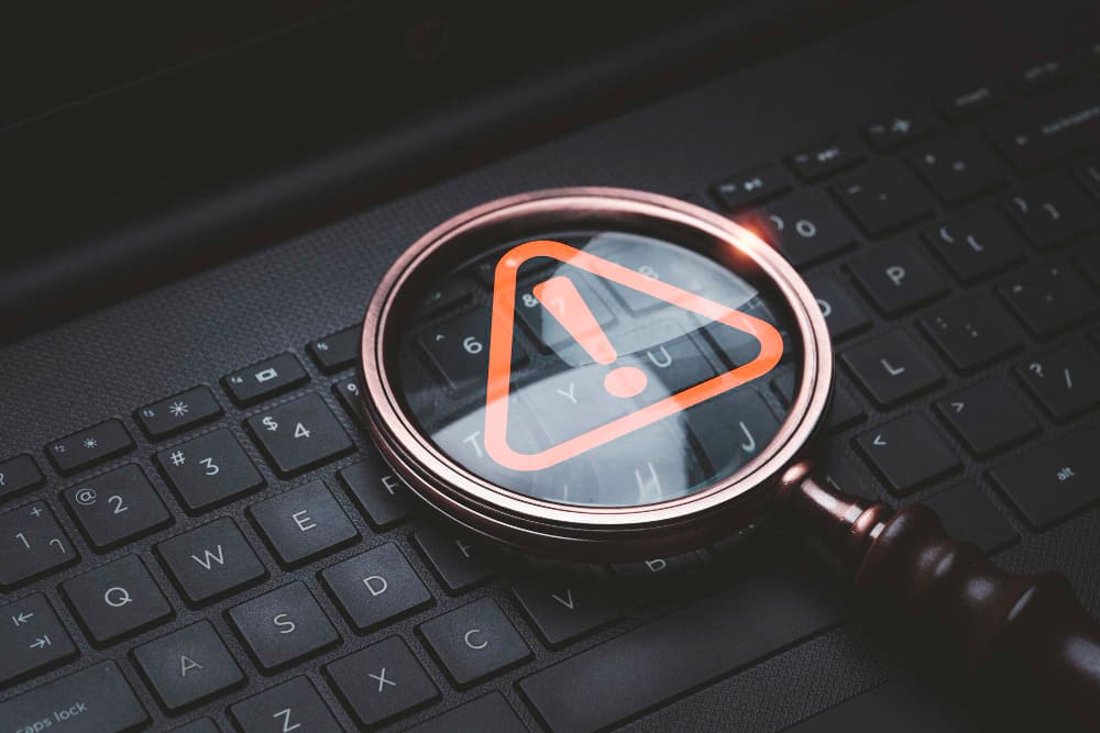 A caution warning sign on a laptop keyboard