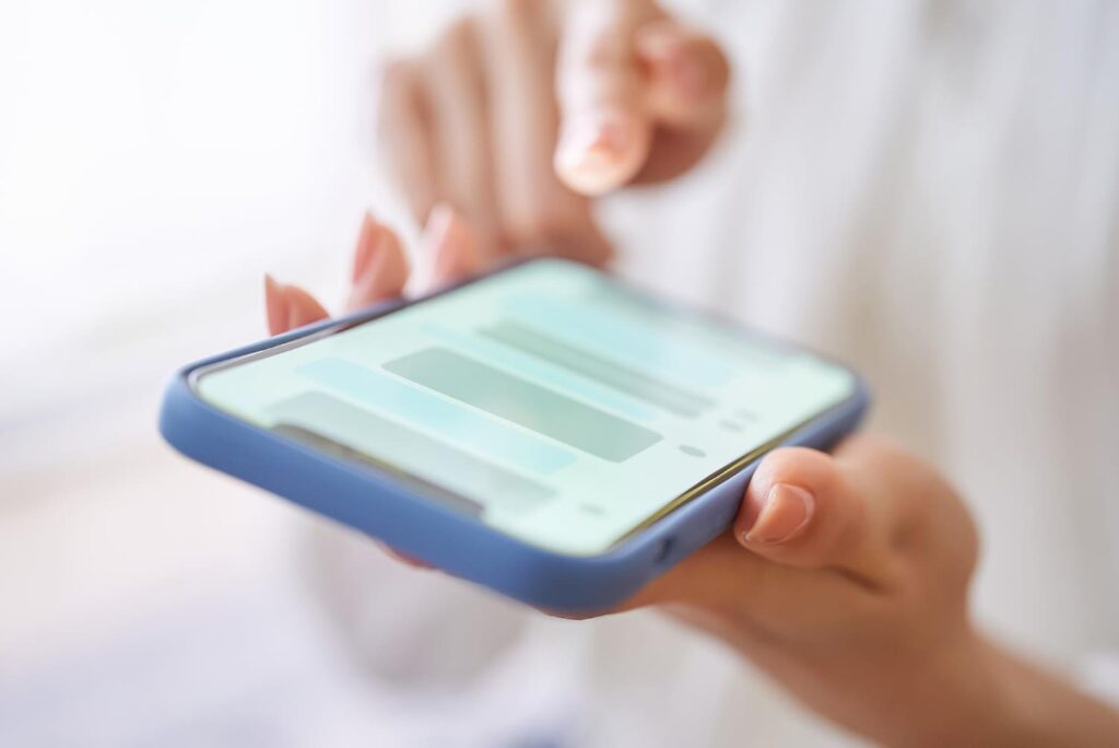 A woman exchanging messages on her phone