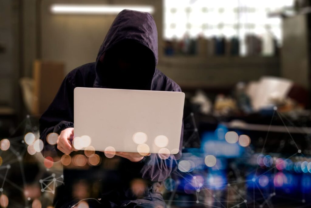 A hacker holding a laptop