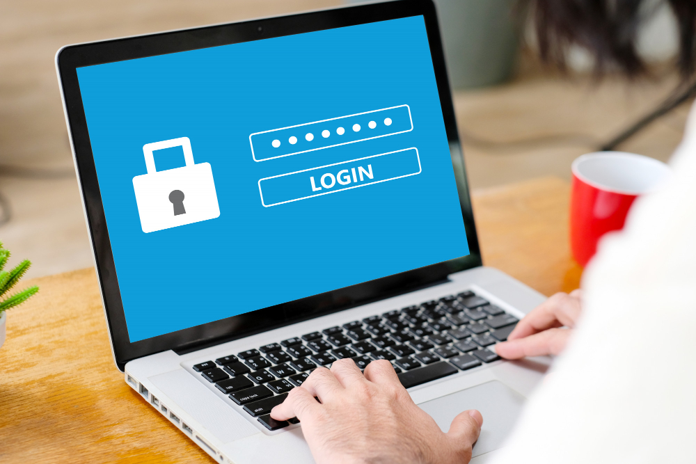 A man trying to login into his account from a laptop