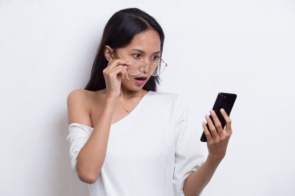 A woman being shocked because of a scam alert