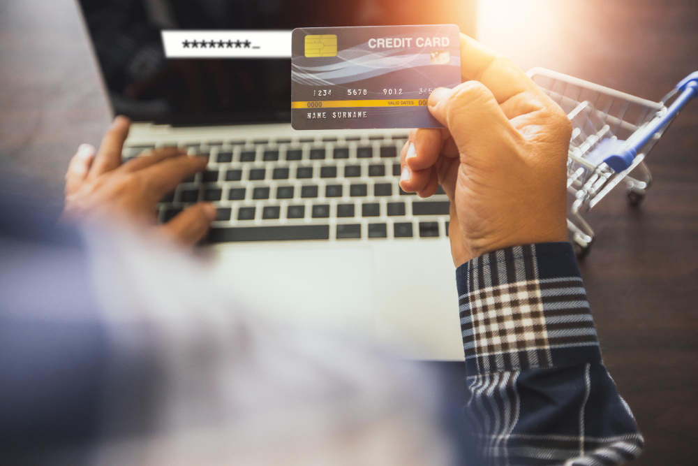 A man inserting his credit card info into a web