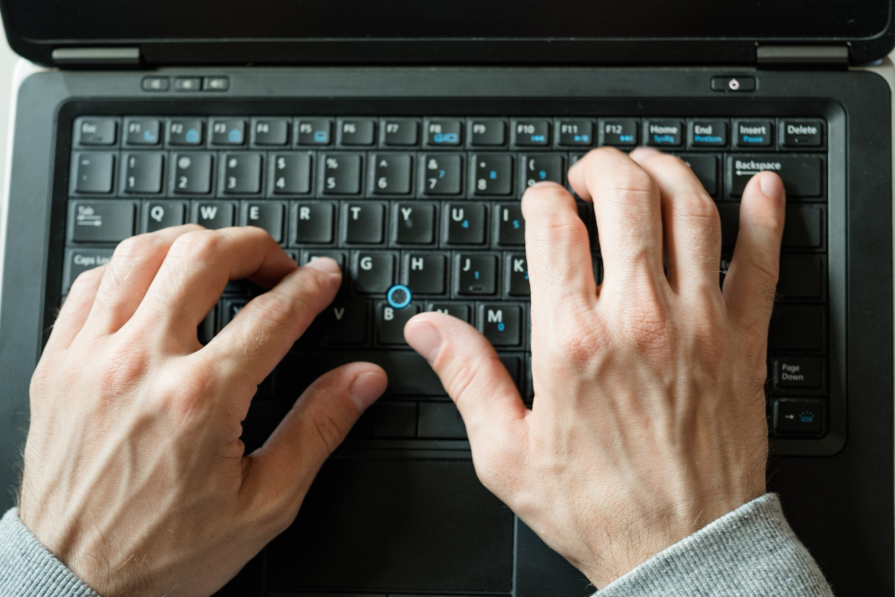 Man hands typing on the laptop keyboard