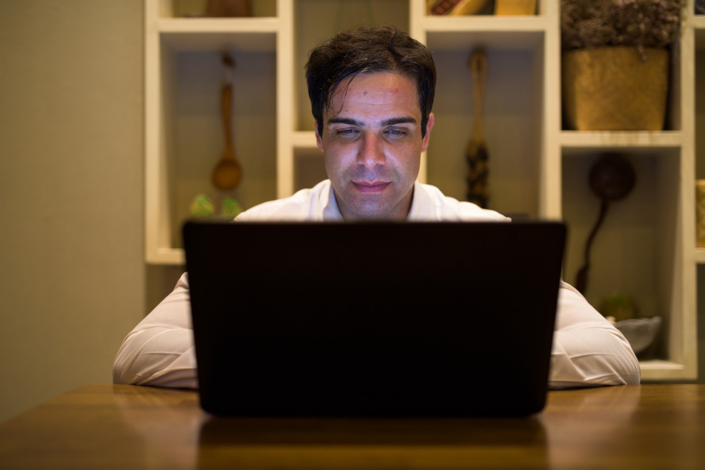 A man activity in front of a laptop