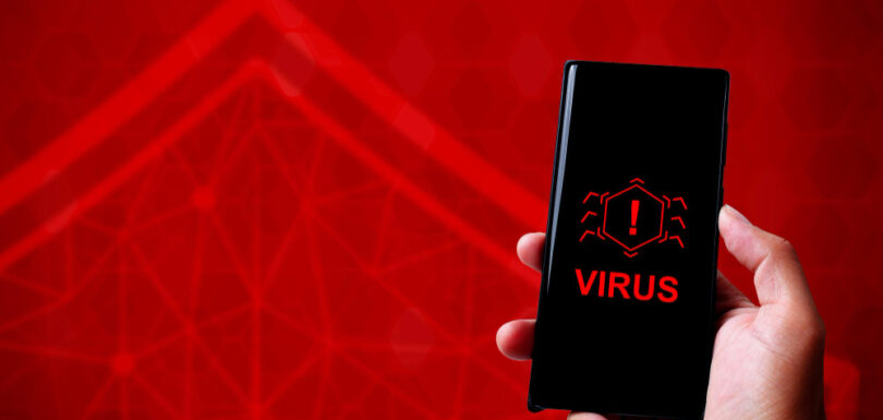 A hand holding a smartphone that showing ILOVEYOU virus